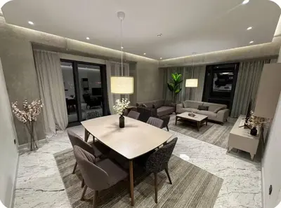 a dining room with a table and a living room at Enjoy luxury family apt in Istanbul