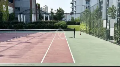 a tennis net on a tennis court in a city at Enjoy luxury family apt in Istanbul