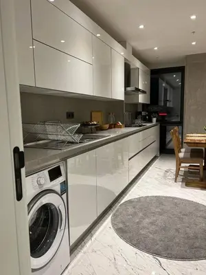 a kitchen with a washing machine in a room at Enjoy luxury family apt in Istanbul