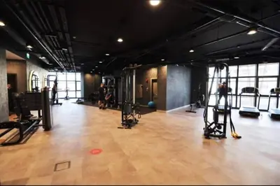 a gym with a bunch of equipment in a room at Cozy luxury apt in Sinpas queen in Istanbul