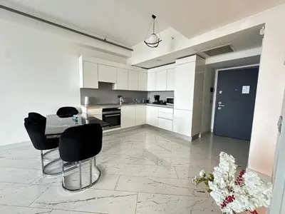a kitchen with a table and black chairs in it at Luxury apt in the 40 plus floor in Istanbul