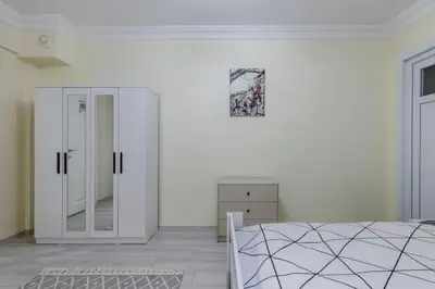 a bedroom with a bed and a mirror on the wall at Fatih'te yeni 3 odalı Daire No 1 in Istanbul
