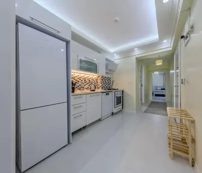 a large kitchen with white cabinets and a large doorway at Fatih'te yeni 3 odalı Daire No 1 in Istanbul