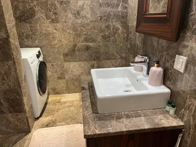 a bathroom with a sink and a washing machine at ultra lüxs in Istanbul