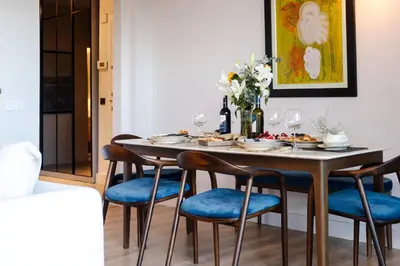 a dining room with a table with blue chairs at Bosphorus Designer Suite Seperate Guest room in Istanbul