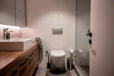 a bathroom with a white toilet and a sink at Bosphorus Designer Suite Seperate Guest room in Istanbul