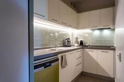 a kitchen with white cabinets and a sink at Bosphorus Designer Suite Seperate Guest room in Istanbul
