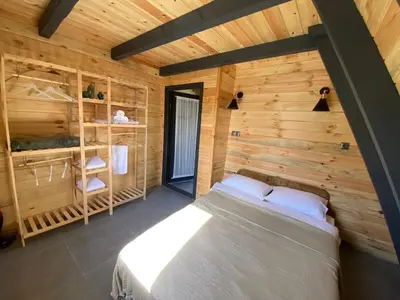a bedroom with a bed in a wooden cabin at Bonte Sapanca in Feyziye