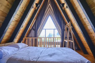 a bed in a room with a large window at Bonte Sapanca in Feyziye
