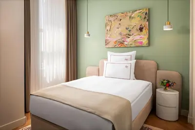 a bedroom with a bed and a painting on the wall at Casa Foscolo Hotel, Istanbul, a Member of Design Hotels in Istanbul