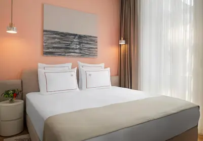 a bedroom with a large bed with white pillows at Casa Foscolo Hotel, Istanbul, a Member of Design Hotels in Istanbul