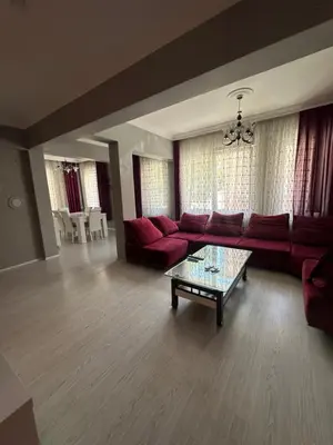 a living room with red couches and a coffee table at Bursa central house in Bursa