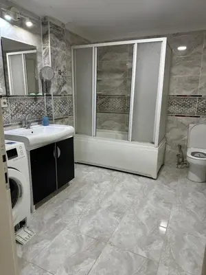 a bathroom with a sink and a washing machine at Bursa central house in Bursa