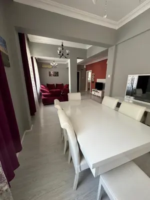 a dining room with a white table and white chairs at Bursa central house in Bursa