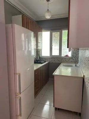 a kitchen with a white refrigerator and a window at Bursa central house in Bursa