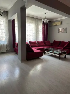 a living room with a red couch and a table at Bursa central house in Bursa