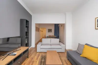 a living room with a couch and a table at Trendy Waterfront Apt with a Striking View in Istanbul