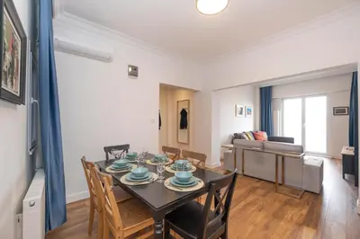 a dining room and living room with a table and chairs at Trendy Waterfront Apt with a Striking View in Istanbul