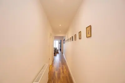 a long hallway with white walls and wooden floors at Trendy Waterfront Apt with a Striking View in Istanbul