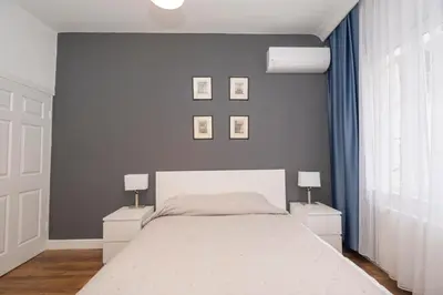 a bedroom with a large bed with two night stands at Trendy Waterfront Apt with a Striking View in Istanbul