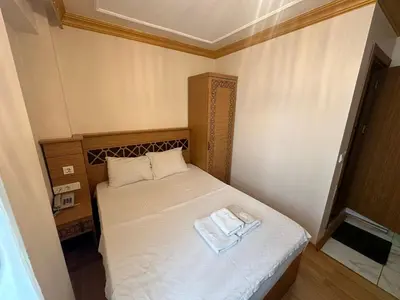 a small bedroom with a bed with two towels on it at Delbab PANSİYON in Istanbul