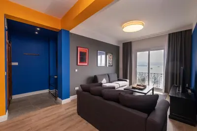 a living room with a couch and a blue wall at Hip Waterfront Apt with a Striking View in Istanbul