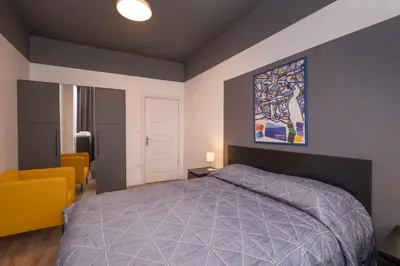 a bedroom with a bed and a painting on the wall at Hip Waterfront Apt with a Striking View in Istanbul