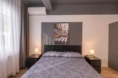a bedroom with a bed and two night stands with lamps at Hip Waterfront Apt with a Striking View in Istanbul