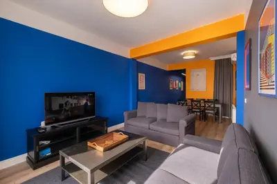 a living room with a couch and a tv at Hip Waterfront Apt with a Striking View in Istanbul