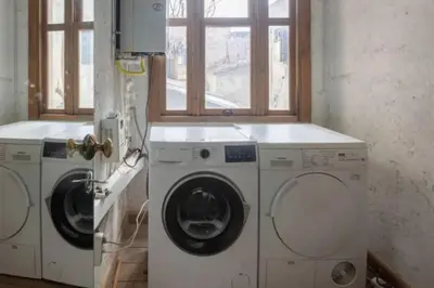 a laundry room with two washing machines and a window at Balat luxury House With Sea View in Istanbul