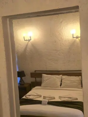 a bedroom with a bed with two lights on the wall at Balat luxury House With Sea View in Istanbul