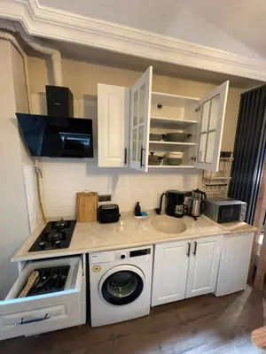 a kitchen with a sink and a washing machine at Golden Arrow Taksim 1 in Istanbul