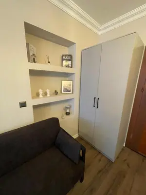 a living room with a couch and a cabinet at Golden Arrow Taksim 1 in Istanbul