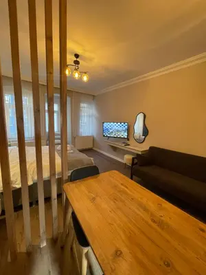 a bedroom with a bed and a couch and a desk at Golden Arrow Taksim 1 in Istanbul