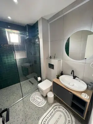 a bathroom with a shower and a toilet and a sink at Golden Arrow Taksim 1 in Istanbul