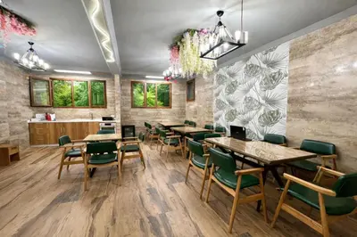 a restaurant with wooden tables and green chairs at Kilic Boutique Hotel in Istanbul