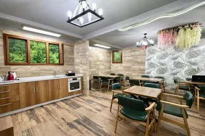 a dining room with tables and chairs and a kitchen at Kilic Boutique Hotel in Istanbul