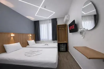 a hotel room with two beds and a mirror at Kilic Boutique Hotel in Istanbul
