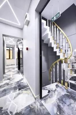 a lobby with a spiral staircase with marble floors at Kilic Boutique Hotel in Istanbul