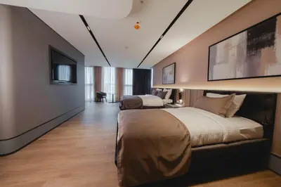 a bedroom with two beds and a flat screen tv at Romatem Move İstanbul Disabled Hotel in Istanbul