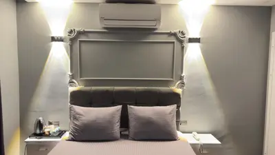 a bedroom with a bed with a projector on the wall at Cevas Suite Hotel in Istanbul