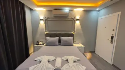 a bedroom with a bed with two white towels on it at Cevas Suite Hotel in Istanbul