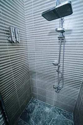 a shower with a light on top of it at Cevas Suite Hotel in Istanbul
