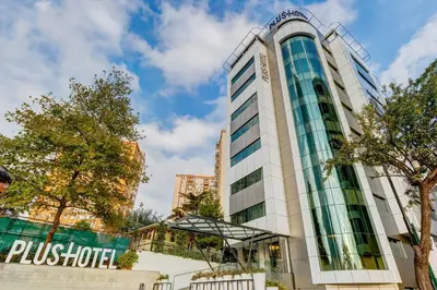 a tall building with a sign on it at Plus Hotel Bostanci Atasehir in Istanbul