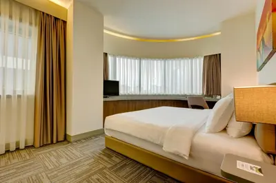 a hotel room with a bed and a window at Plus Hotel Bostanci Atasehir in Istanbul