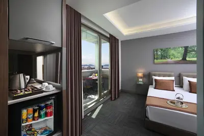 a hotel room with a bed and a window at Plus Hotel Bostanci Atasehir in Istanbul
