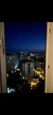 a view of a city at night from a window at KÖYLÜM RESİDENCE-2 Bostancı in Istanbul