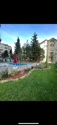 a swimming pool in a park with green grass at KÖYLÜM RESİDENCE-2 Bostancı in Istanbul