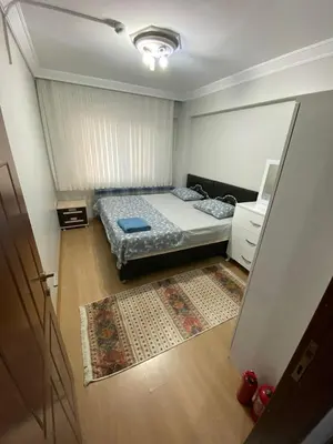 a small bedroom with a bed and a rug at İsra home 2 in Istanbul