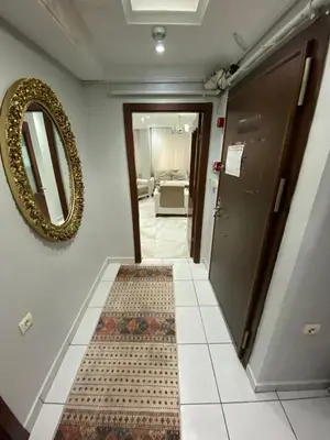 a hallway with a mirror and a tile floor at İsra home 2 in Istanbul